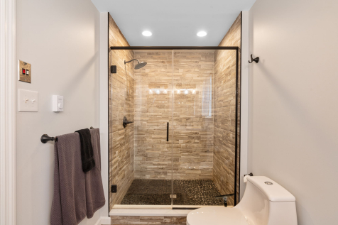 A bathroom with a glass shower and toilet AI-generated content may be incorrect., Picture