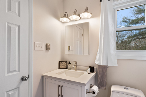 A bathroom with a sink and a mirror AI-generated content may be incorrect., Picture