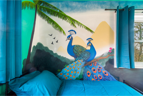 A bed with a painting of birds and trees AI-generated content may be incorrect., Picture