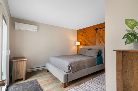 A bedroom with a bed and a door AI-generated content may be incorrect., Picture