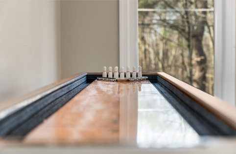A bowling alley with white pins on a table AI-generated content may be incorrect., Picture