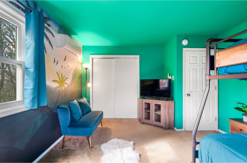 A room with a blue couch and a white door AI-generated content may be incorrect., Picture